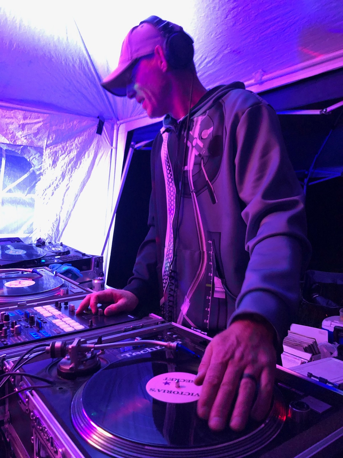 DJ Natural Nate® on Technics turntables under purple tent lighting with Victoria's Secret slipmat